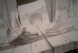 boy peering through a double pair of shoes